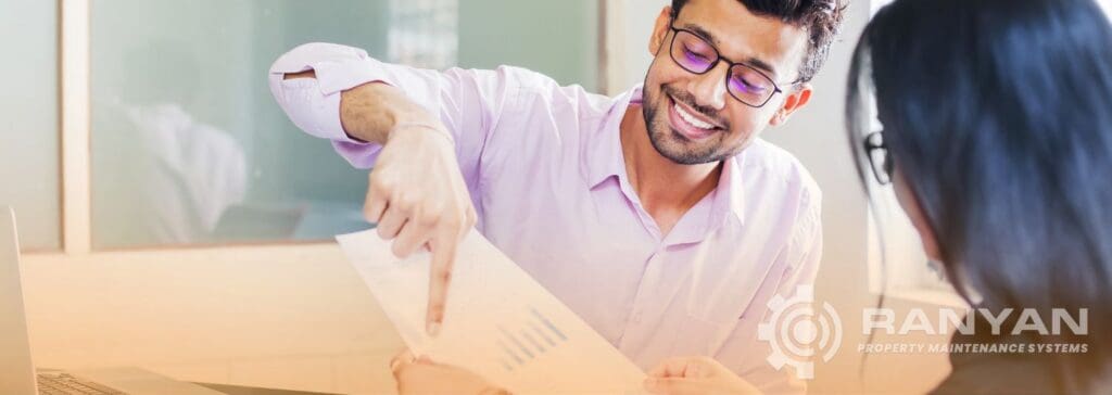 Cleaning company owner walking a client through a detailed service report